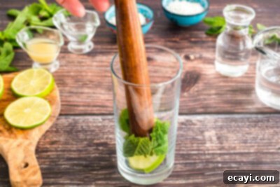 Island Coconut Dream 10 muddling mint and lime in glass