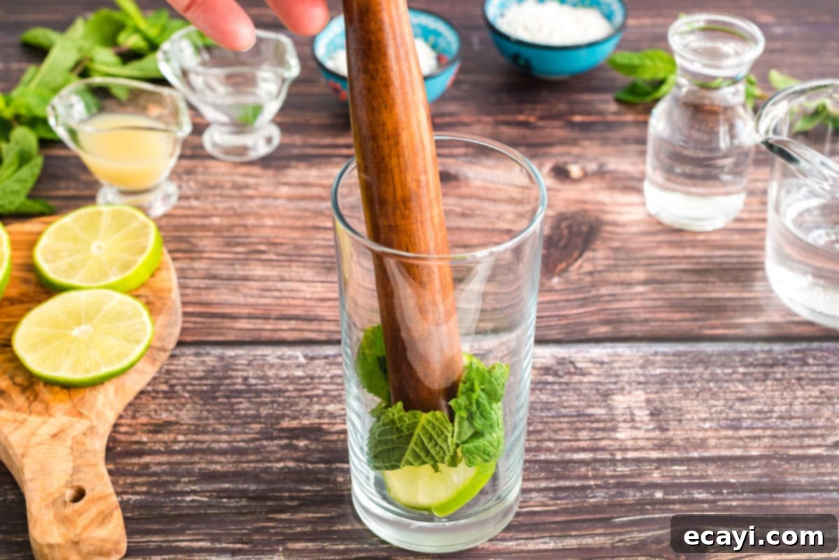 Island Coconut Dream 3 muddling mint and lime in glass