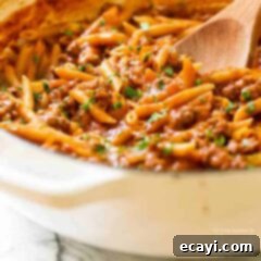 Hearty One-Pot Sloppy Joe Pasta Skillet 2 pan of sloppy joe pasta with a wooden spoon