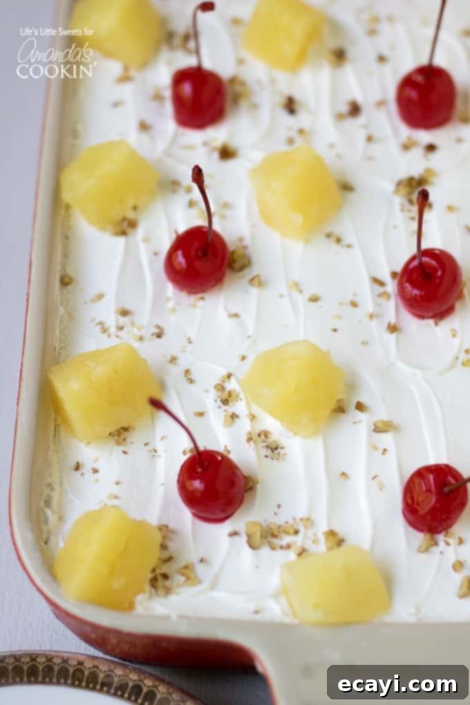 Decadent Banana Split Treat 3 Banana Split Dessert Recipe with pineapple and cherry topping - A close-up of the layered dessert