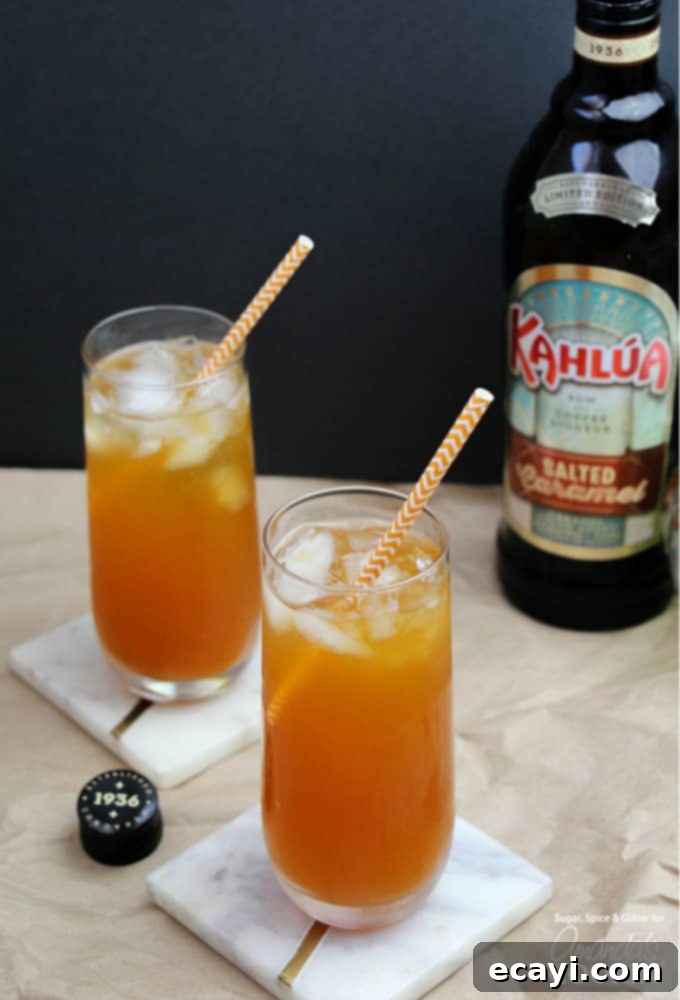 This Caramel Pumpkin Cocktail is a delicious way to enjoy all of your favorite fall flavors like caramel and pumpkin, in one icy cocktail! #fallcocktails #pumpkincocktail #pumpkindrinks #cocktails #applecidercocktails #falldrinks #kahluadrinks #saltedcaramel #kahlua Caramel Pumpkin Cocktails in glasses with striped straws and Kahlua