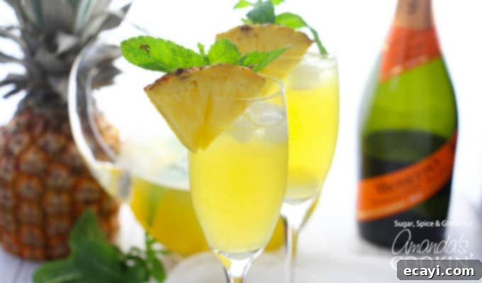 This Pineapple Prosecco Punch is bursting with pineapple, white rum, mango juice, Prosecco and a hint of mint. Perfect for sipping and relaxing! #cocktail #brunch #summercocktails #summerdrinks #partydrinks #prosecco #pineapple #wine #rum #brunchcocktail Single flute of Pineapple Prosecco Punch with a pineapple wedge garnish, highlighting the refreshing tropical flavors and festive presentation.