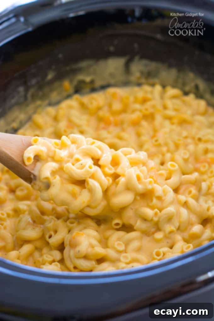 Creamy No-Boil Slow Cooker Mac and Cheese: The Ultimate Easy Recipe for Perfect Indulgence #crockpot #macandcheese #dinner #slowcooker creamy macaroni and cheese in a crockpot, ready to serve