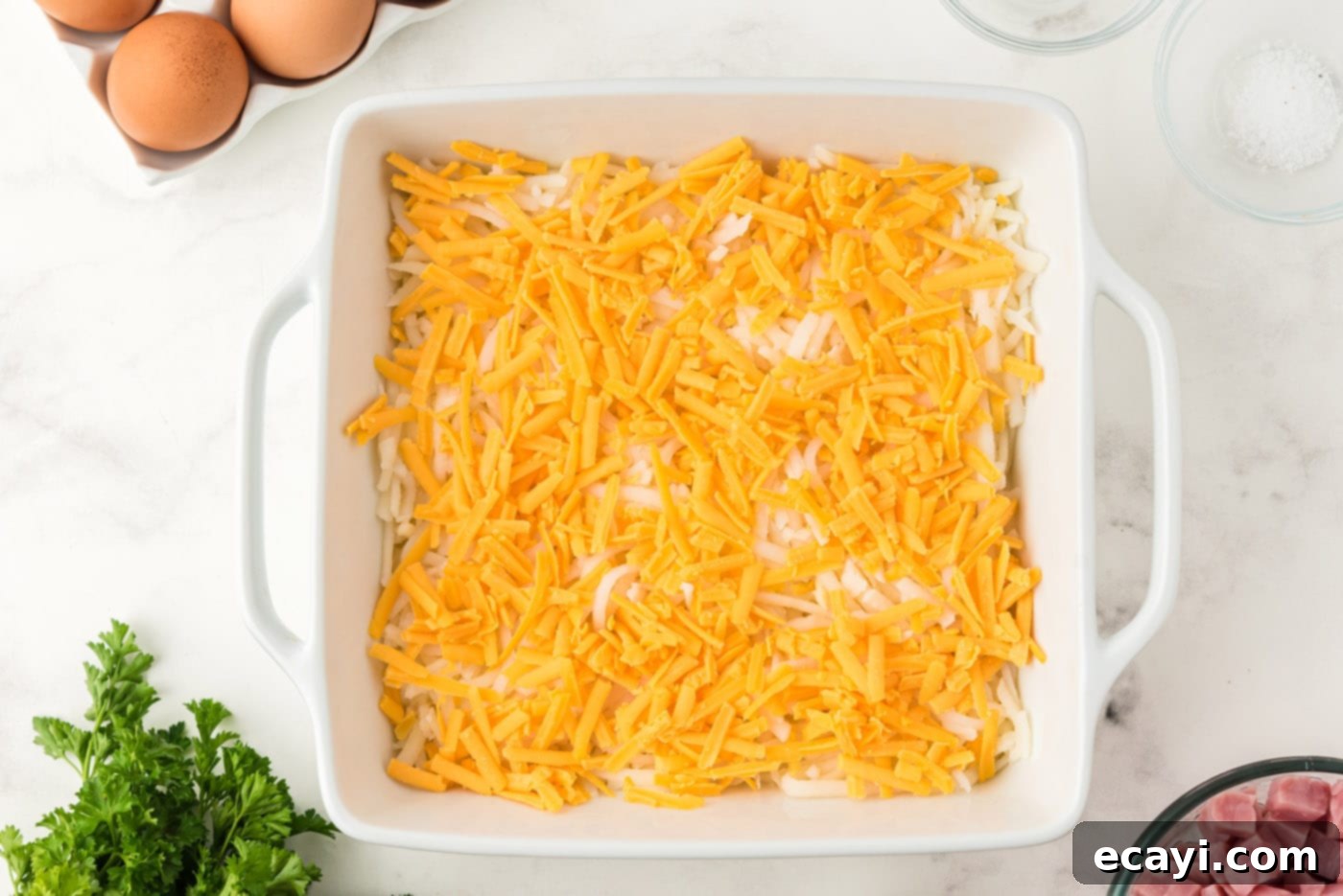 Savory Ham and Cheese Morning Bake 6 Generous layer of shredded cheddar cheese in a baking dish