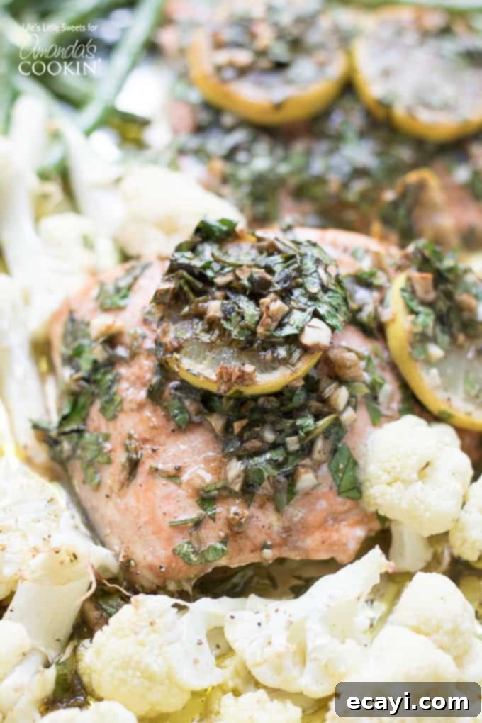Delicious Sheet Pan Salmon Dinner recipe for a quick and easy weeknight meal Overview of a cooked Sheet Pan Salmon Dinner with perfectly roasted salmon, green beans, and cauliflower, garnished with fresh herbs.