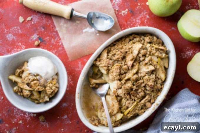 This baked apple crisp will be a new family favorite, especially with a scoop of vanilla ice cream on top! Close-up of baked apple crisp in a bowl, ready to be enjoyed.
