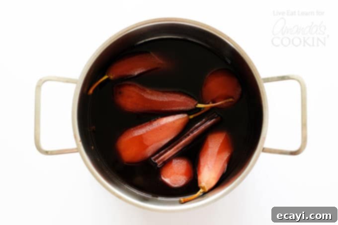 Luscious Red Wine Pears 4 pears stewing in pot with red wine and spices