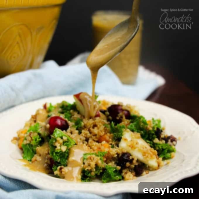 This fall Quinoa Salad is delicious served warm or cold. Either way you choose to make it, our Maple Walnut Vinaigrette tops this salad off perfectly. drizzling dressing on salad
