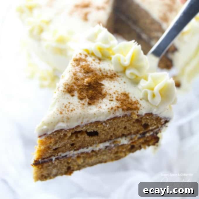 This spice cake has all of the classic flavors of fall - pumpkin spice, cinnamon, apple, even a hint of molasses then topped with a cream cheese frosting. slice of spice cake on spatula