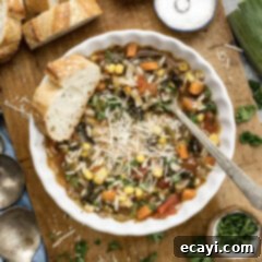 Hearty Veggie Rice Soup 11 Bowl of Vegetable Rice Soup with bread to the side, a perfect cozy meal