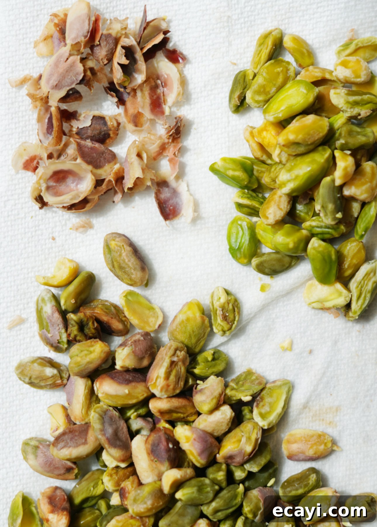 Velvet Raspberry Pistachio Semifreddo 6 Hands peeling blanched pistachios to achieve a smoother paste for semifreddo