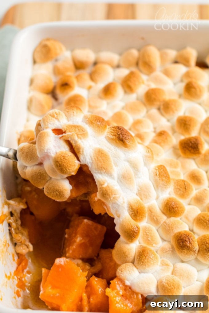 Caramelized Yams 4 scooping candied yams with browned marshmallows from pan