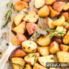 Aromatic Rosemary Garlic Potatoes 5 serving spoon picking up roasted potates