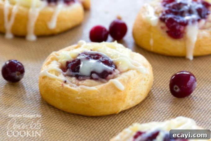 Cranberry Cream Cheese Pastries: Crescent roll dough is filled with vanilla cream cheese, tart cranberry sauce and a drizzle of sweet icing. cranberry cream cheese filled pastries with icing