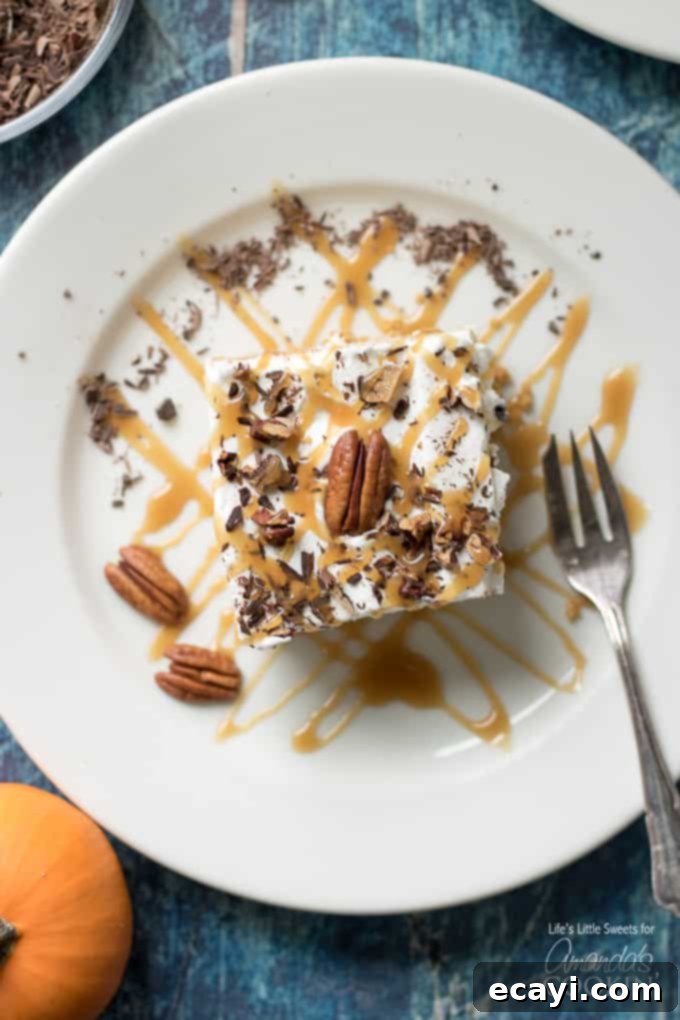 This Pumpkin Lasagna has a graham cracker crust, a sweet cream cheese layer, pumpkin spice Jello pudding, Cool Whip and topped with pecans. slice of pumpkin dessert on plate
