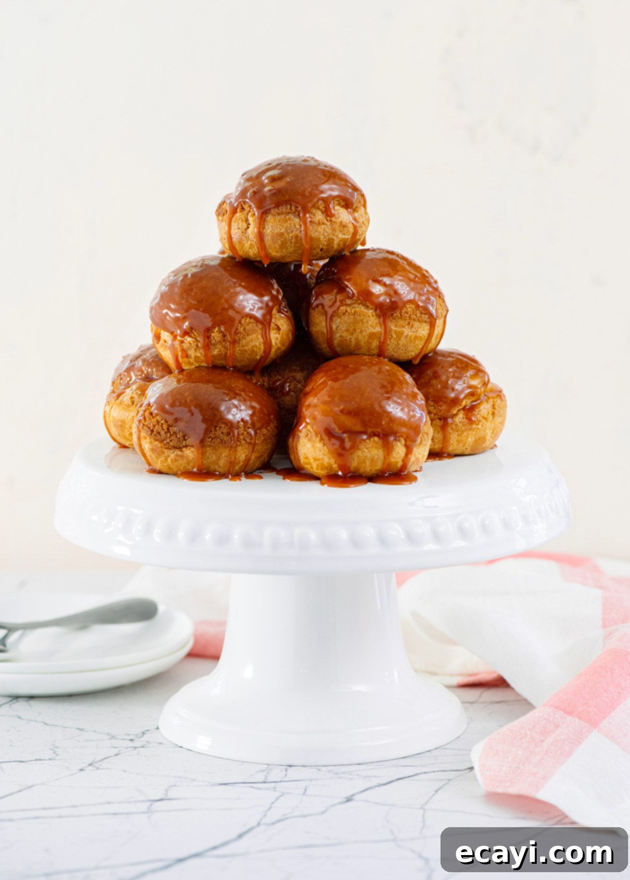 Close-up of freshly baked salted caramel cream puffs, ready for filling.