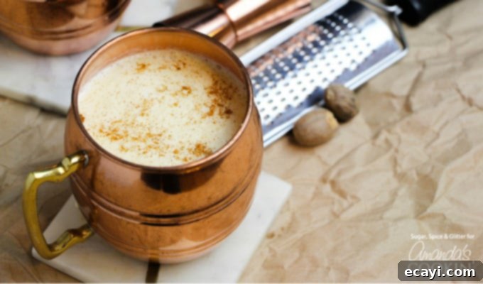 Homemade Eggnog Cocktail: A thick, rich, and flavorful holiday drink made with eggs, sugar, milk, cream, rum, and nutmeg. Perfect for your festive party. A festive glass of homemade eggnog drink, perfectly chilled and ready to enjoy during the holiday season, embodying comfort and joy.