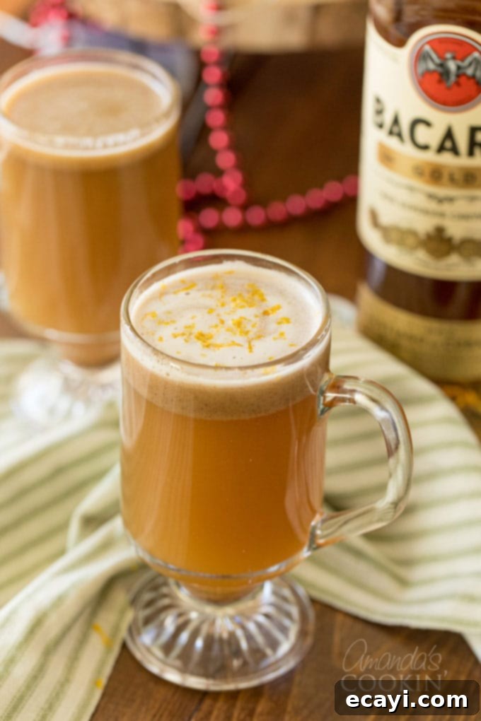 A Hot Buttered Rum - AKA a hot toddy - is a dessert-like cocktail with a rich, buttery flavor that is gently spiced and finished off with a twist of orange. 2 glass mugs of buttered rum
