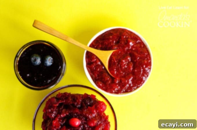 Easy Homemade Berry Jam recipe in three distinct flavors for every palate. Close-up of three jars of homemade berry jam: strawberry, blueberry, and cranberry, showcasing their vibrant colors.