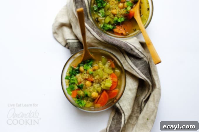 Warm and inviting healthy vegetable soup with quinoa and chickpeas, served in bowls. #chickpeas #soup #healthy #vegetarian #vegetariansoup #souprecipes #winterrecipes #vegetablesoup Healthy vegetable soup in bowls, ready to be enjoyed