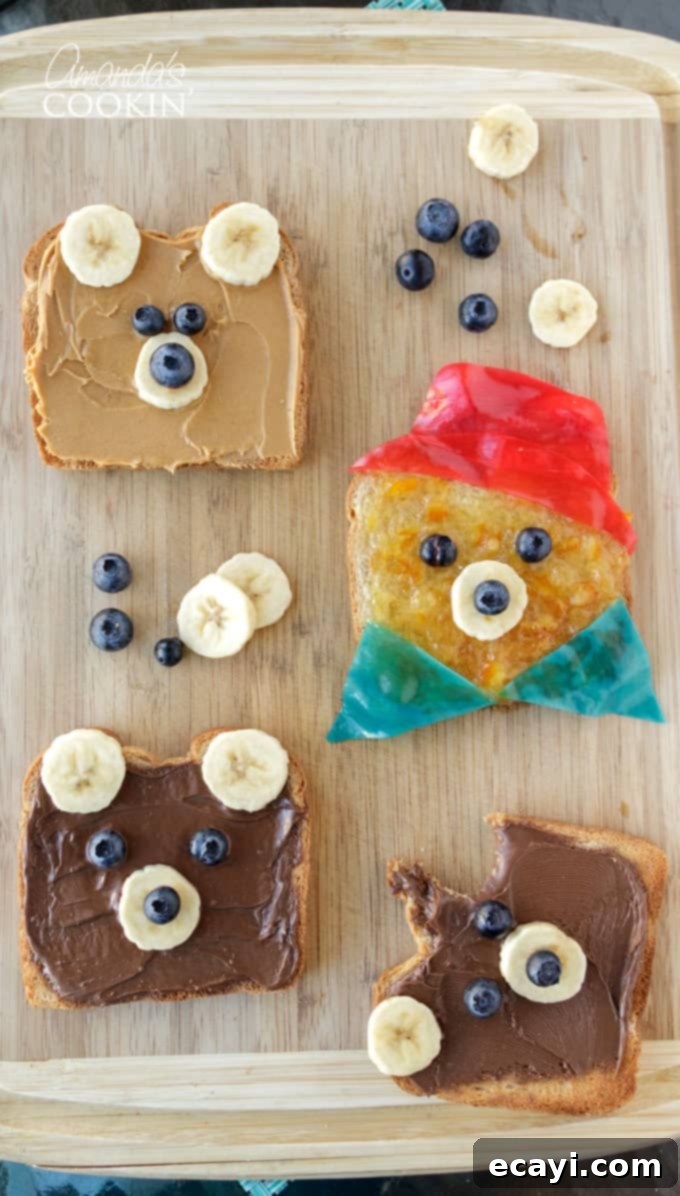 Making this delightful Paddington Bear toast is quick and easy, taking under 10 minutes—ideal for a fun food-craft with your kids! #paddington #teddybeartoast #toast #cutefood Adorable Paddington Bear toast on a cutting board, topped with bananas, blueberries, and fruit roll-up hat and collar, perfect for a fun kids' breakfast.