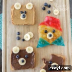 Paddington's Signature Marmalade Toast 2 Delightful toast decorated to resemble Paddington Bear on a wooden cutting board, a perfect fun breakfast or snack for children.