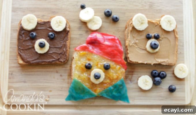 Crafting this bear toast is quick and straightforward, making it the ultimate food-craft to enjoy with your children in under 10 minutes! Two hands, likely a child's, carefully placing a blueberry eye on a Paddington Bear toast, illustrating the interactive and fun nature of making this breakfast.