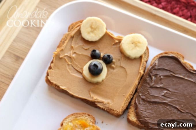 This bear toast is quick and easy to make, serving as the perfect food-craft to enjoy with your children in under 10 minutes! Adding two blueberry eyes to the Paddington Bear toast, positioned on the toast with the banana ears and nose already in place.