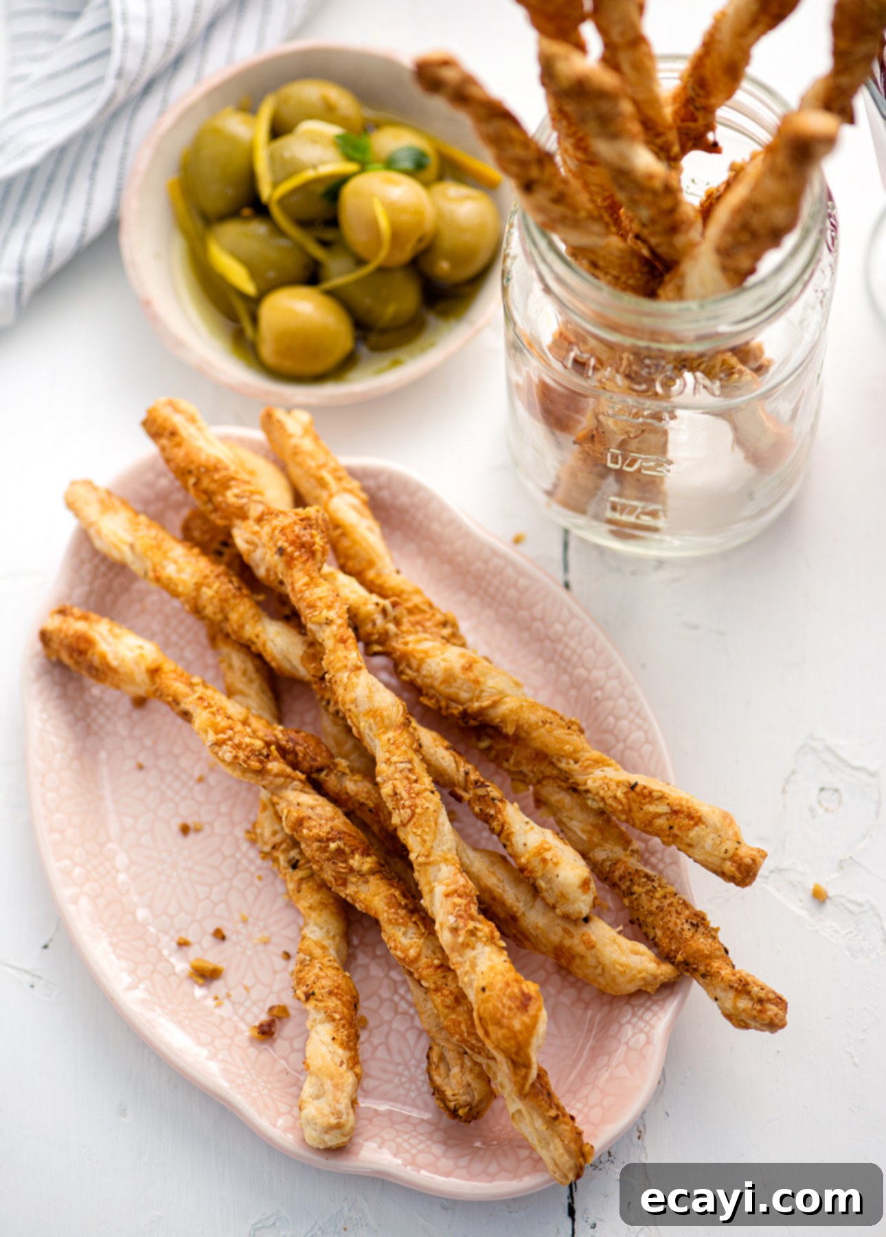 Effortless Cheesy Twists 2 Golden brown cheese straws on a serving board