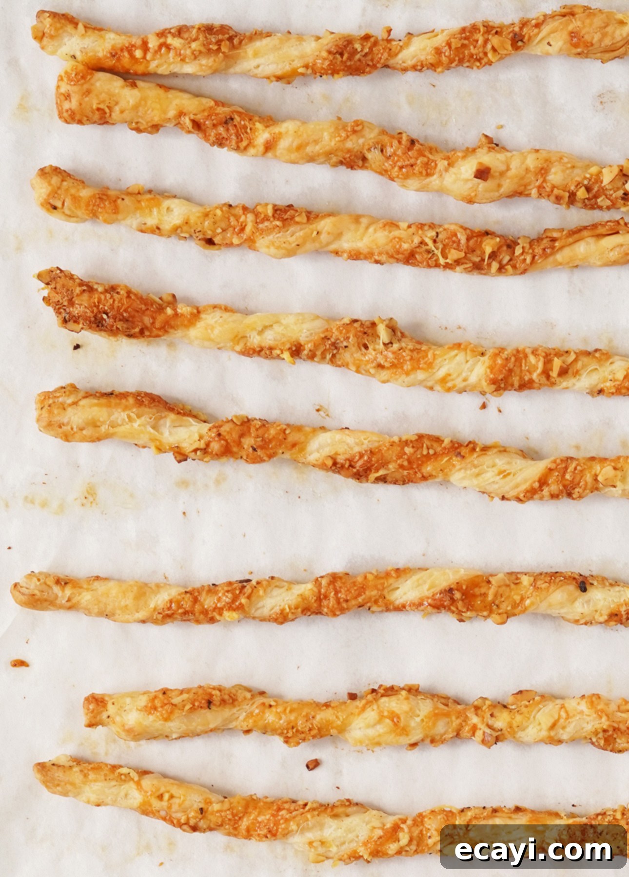 Effortless Cheesy Twists 6 Pile of easy cheese straws on a wooden board