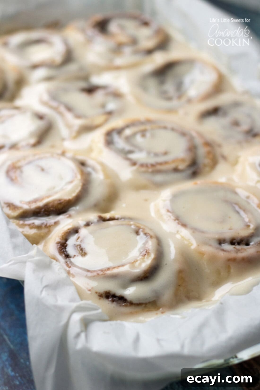 These Homemade Cinnamon Rolls are a true classic. Topped with cream cheese frosting, these gooey cinnamon rolls satisfy your sweet craving! They also make the perfect holiday morning breakfast with the family. #breakfast #cinnamonrolls #breadrecipes #holidaybreakfast #dough #cinnamon Homemade Cinnamon Rolls in a pan, topped with cream cheese frosting