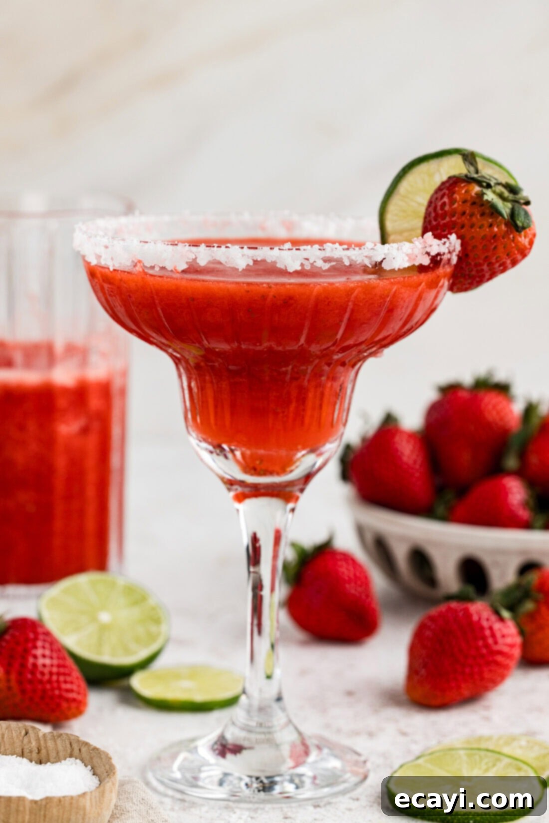 Berry Burst Margarita 11 A side view of a perfectly crafted frozen strawberry margarita, beautifully garnished with a lime wheel and a fresh strawberry, ready to be enjoyed.