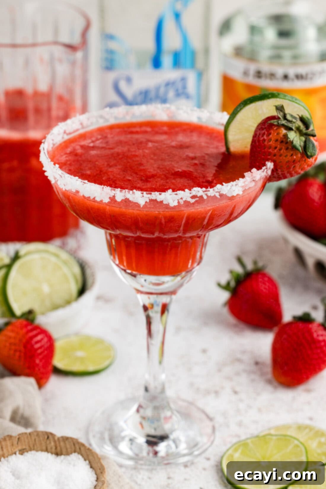 Berry Burst Margarita 3 Close-up view of a perfectly blended frozen strawberry margarita, showcasing its vibrant red color and icy texture.