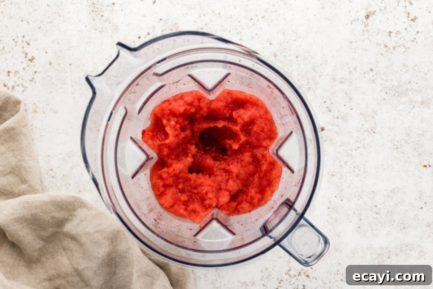 Berry Burst Margarita 7 Overhead view of a perfectly blended frozen strawberry margarita mixture swirling smoothly in a blender, indicating ideal consistency.