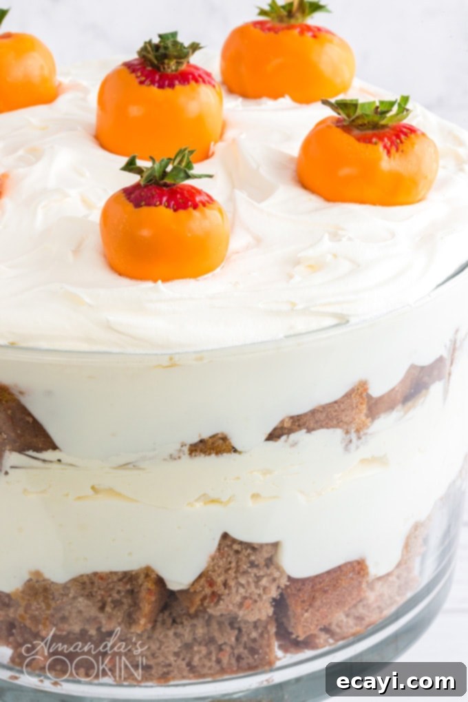 This carrot cake trifle has layers of moist carrot cake and no-bake cheesecake filling then topped with adorable strawberry  close up of carrot trifle layered dessert