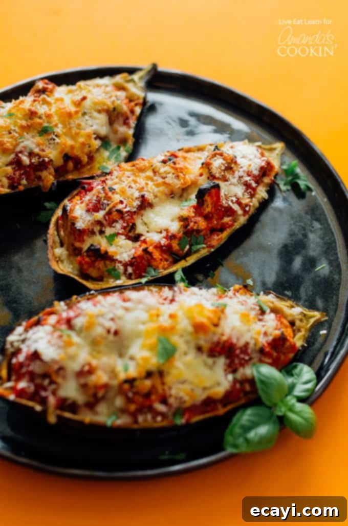 Cheesy Stuffed Eggplant Parmesan 2 Cooked stuffed eggplant parmesan on a black plate, ready to serve.