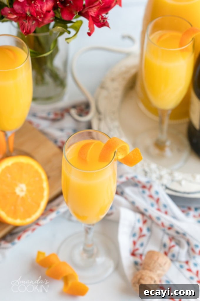 Mimosas are incredibly easy to make and replenish, making them the perfect low-fuss brunch cocktail for all occasions. Combine orange juice and champagne for a delightful treat. a refreshing glass of mimosa garnished with an orange twist