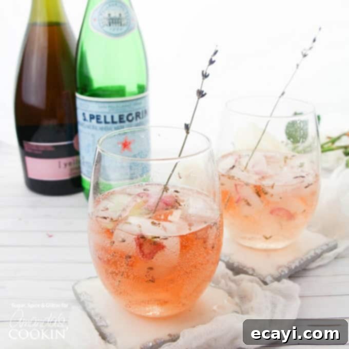 Lavender Rose Spritzer: made with fresh lavender, rose petals and rosé! Perfect for brunch or bridal showers! #rosespritzer #winespritzer #summercocktails #bridalshowerdrinks #brunchcocktails #amandascookin two glasses of rose spritzer