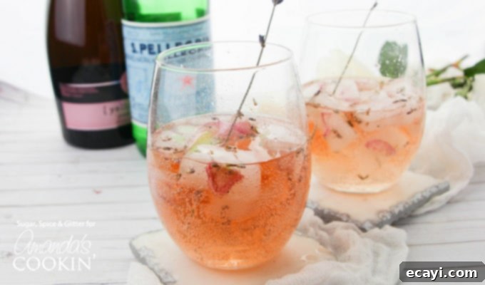 Lavender Rose Spritzer: made with fresh lavender, rose petals and rosé! Perfect for brunch or bridal showers! #rosespritzer #winespritzer #summercocktails #bridalshowerdrinks #brunchcocktails #amandascookin lavender rose spritzer in wine glass with lavender garnish