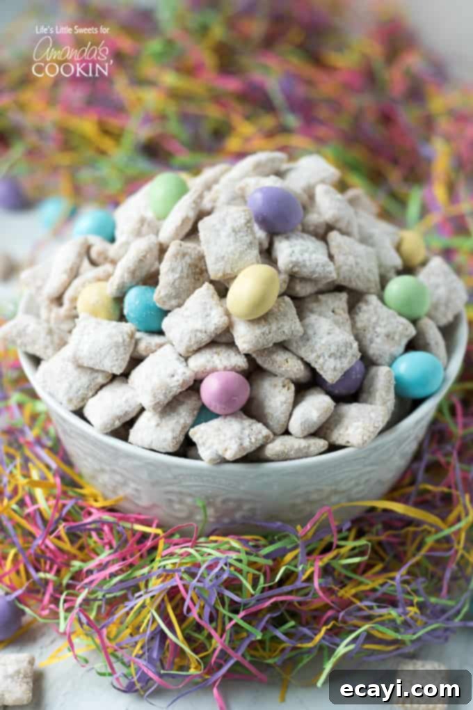 Easter Muddy Buddies are a sweet and salty snack with cereal. Then coated in white chocolate & peanut butter, customized with your favorite Easter candies. #snack #easter #easterdessert #easterrecipes #muddybuddy #puppychow #candy #chexmix #whitechocolate Colorful Easter Muddy Buddies snack