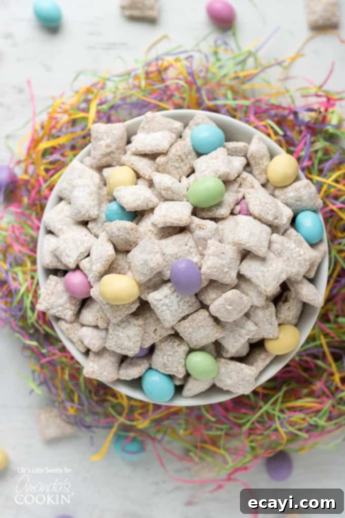 Easter Muddy Buddies are a sweet and salty snack with cereal. Then coated in white chocolate & peanut butter, customized with your favorite Easter candies. #snack #easter #easterdessert #easterrecipes #muddybuddy #puppychow #candy #chexmix #whitechocolate Easter Muddy Buddies