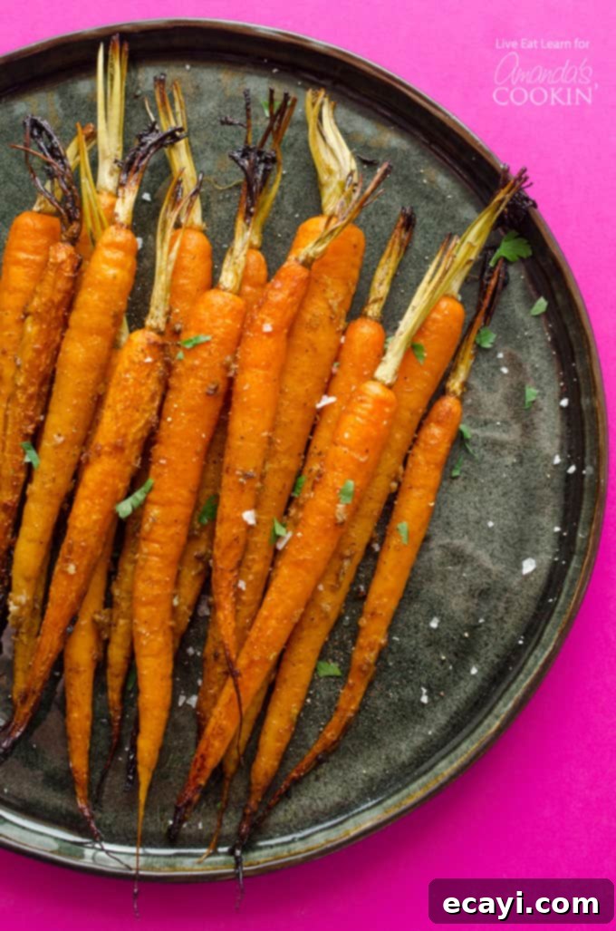 Slow-Cooked Balsamic Glazed Carrots 2 Slow Cooker Balsamic Carrots - a pile of glossy, cooked carrots in a serving dish