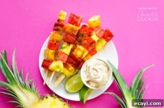 Delicious Grilled Watermelon Pineapple Skewers with Yogurt Dip Platter of perfectly grilled Watermelon and Pineapple Skewers, garnished with fresh mint, alongside a bowl of creamy, sweet yogurt dipping sauce. A perfect healthy summer dessert.