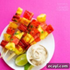 Tropical Fire-Kissed Fruit Kebabs 2 Close-up of a perfectly grilled watermelon and pineapple skewer on a plate, ready to be enjoyed.