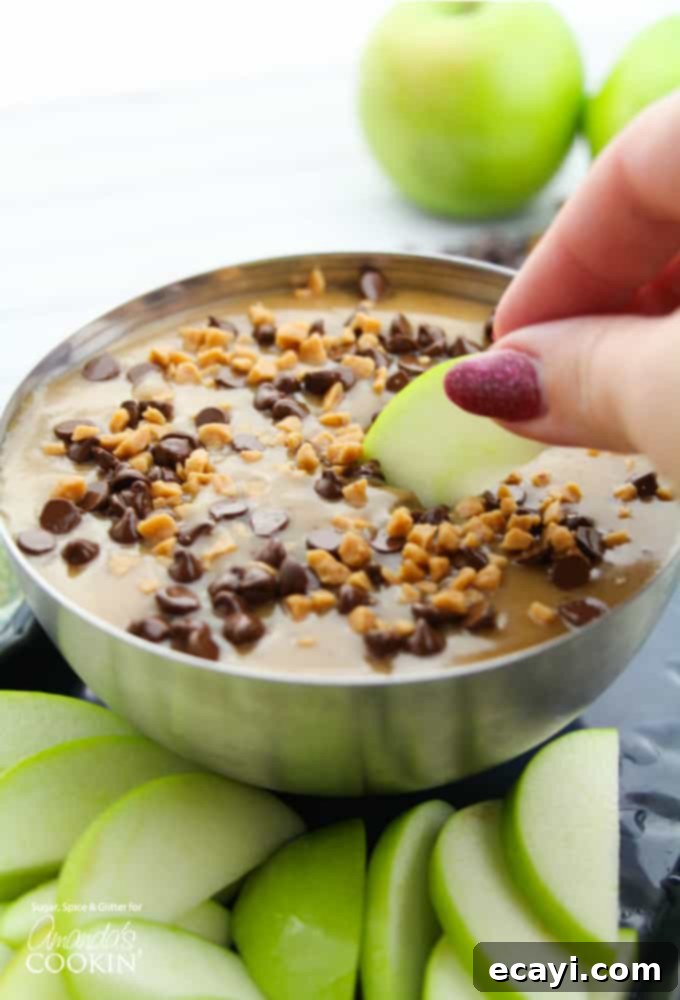 Luscious Caramel Apple Treat 2 Lush, creamy homemade caramel apple dip in a white bowl, perfect for dipping fresh apple slices. A vibrant autumn treat for any occasion.