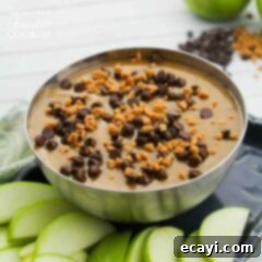Luscious Caramel Apple Treat 7 Homemade Caramel Apple Dip in a silver bowl, garnished with mini chocolate chips and Skor bits. A perfect easy dessert or party snack.
