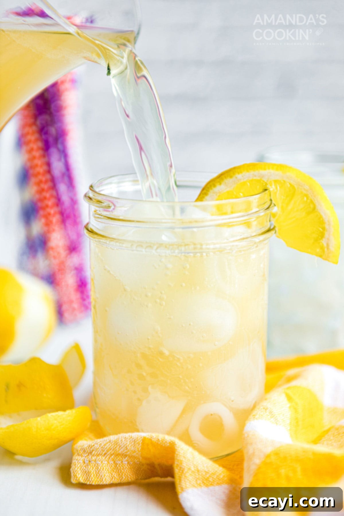 Leave the lemonade for the kids and mix up this Lynchburg Lemonade for your next BBQ - a Jack Daniels-spiked lemon cocktail that is surprisingly smooth. Pouring Lynchburg lemonade into a mason jar glass from a pitcher, garnished with lemon
