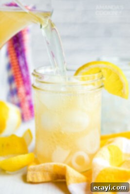 Lynchburg Lemonade 12 pouring Lynchburg lemonade into a mason jar glass form a pitcher