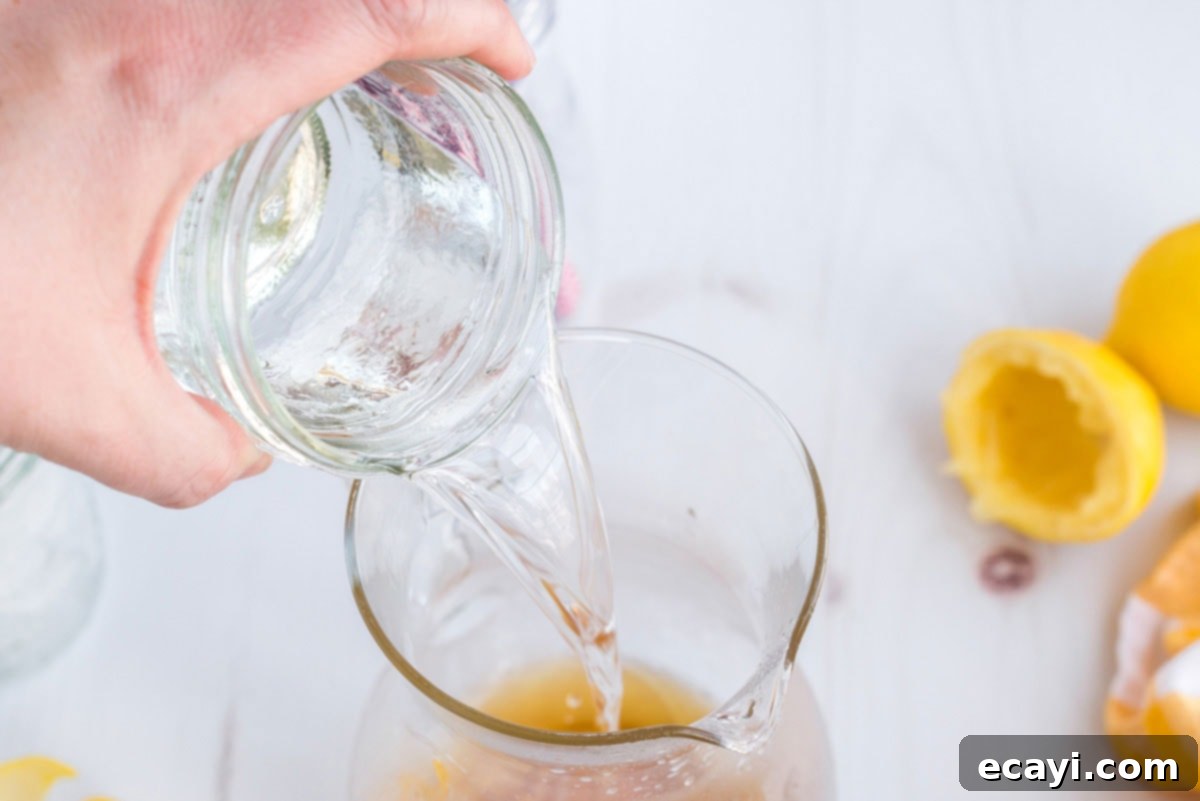 Lynchburg Lemonade 6 Adding Triple Sec liqueur to the pitcher, combining with lemon juice and whiskey