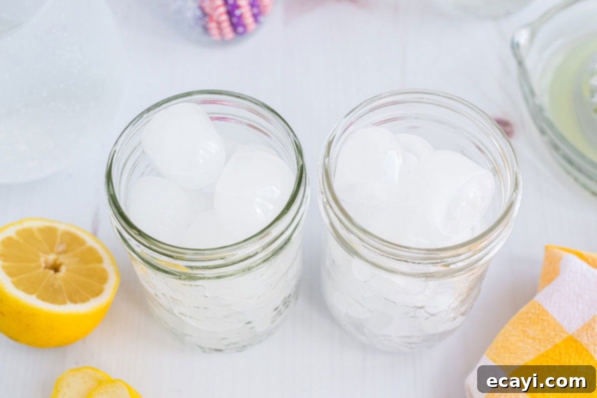 Lynchburg Lemonade 7 Mason jar glasses filled with ice cubes, ready for the lemonade